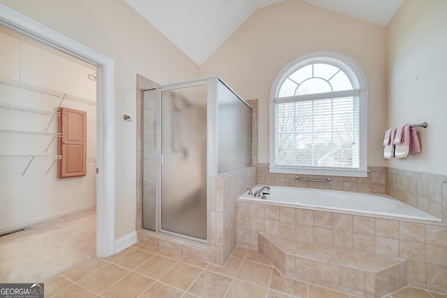 bathroom with visible vents, a shower stall, vaulted ceiling, tile patterned floors, and a bath