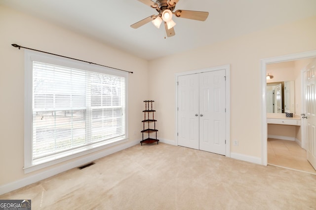 unfurnished bedroom with visible vents, baseboards, carpet, a closet, and a ceiling fan