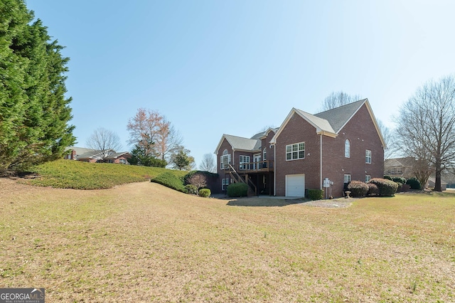 view of home's exterior with brick siding, an attached garage, a wooden deck, and a yard