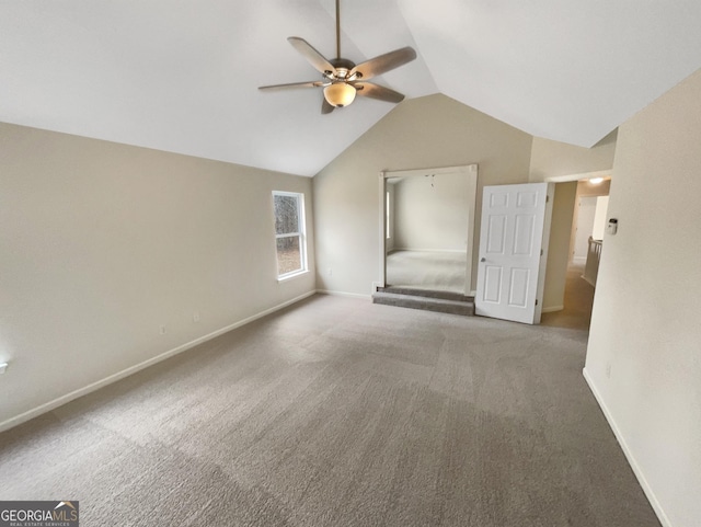 interior space featuring carpet flooring, baseboards, lofted ceiling, and ceiling fan