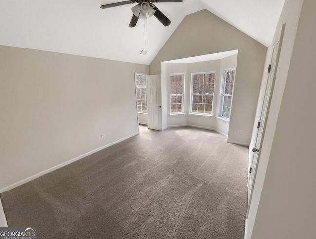 spare room with visible vents, baseboards, ceiling fan, carpet floors, and high vaulted ceiling