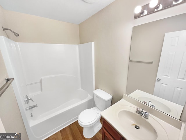 bathroom featuring vanity, bathing tub / shower combination, toilet, and wood finished floors