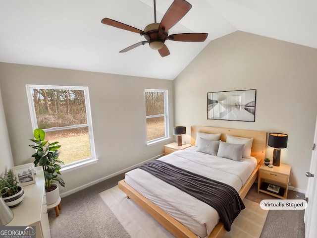 bedroom featuring carpet floors, a ceiling fan, baseboards, and vaulted ceiling