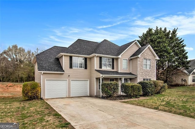 traditional-style home with an attached garage, concrete driveway, and a front lawn