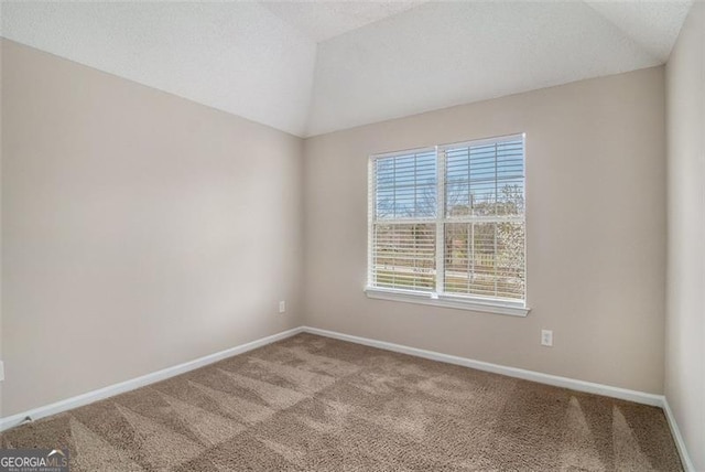 unfurnished room with a textured ceiling, baseboards, carpet, and vaulted ceiling