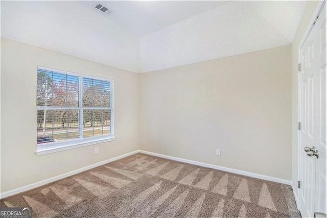 unfurnished room featuring visible vents, baseboards, carpet flooring, and vaulted ceiling