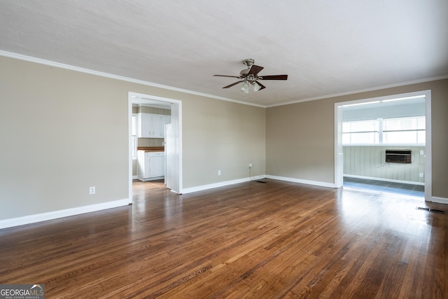 unfurnished room with dark wood finished floors, crown molding, a ceiling fan, and baseboards