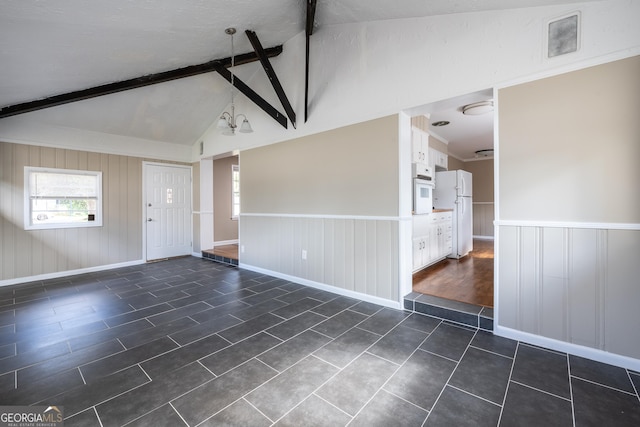 interior space featuring wainscoting and freestanding refrigerator