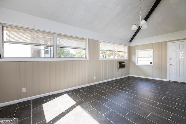 unfurnished sunroom with vaulted ceiling with beams