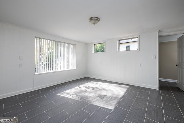 empty room featuring baseboards and wood tiled floor