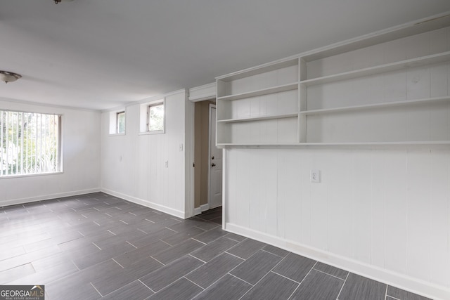 below grade area with baseboards and wood tiled floor