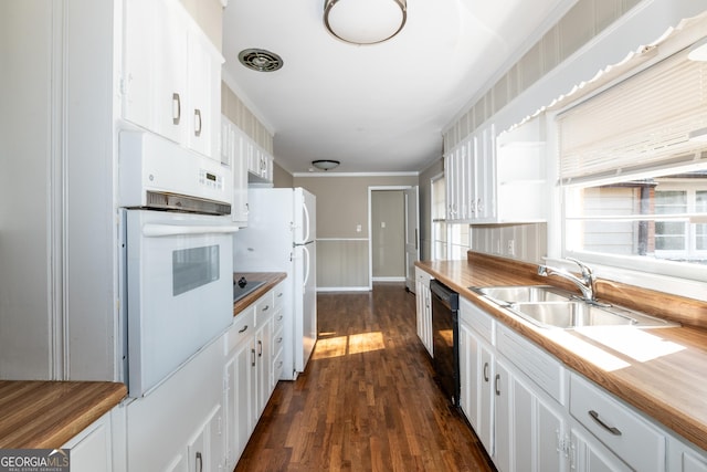 kitchen featuring white appliances, white cabinets, dark wood-style floors, and a sink