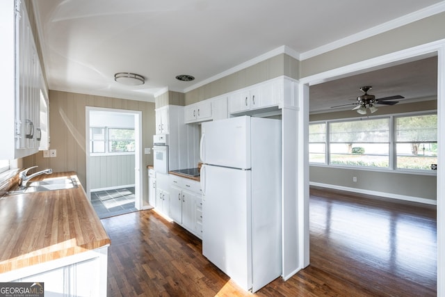 kitchen featuring crown molding, dark wood-type flooring, white cabinets, white appliances, and a sink