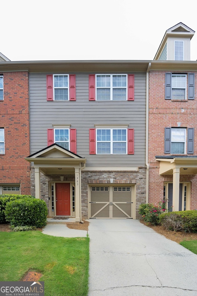 view of property with an attached garage and driveway