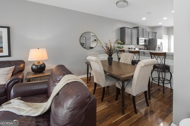 dining room featuring recessed lighting, dark wood-style flooring, and baseboards