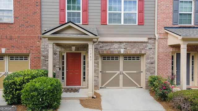 property entrance with a garage and driveway