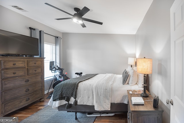 bedroom with visible vents, ceiling fan, and dark wood-style flooring