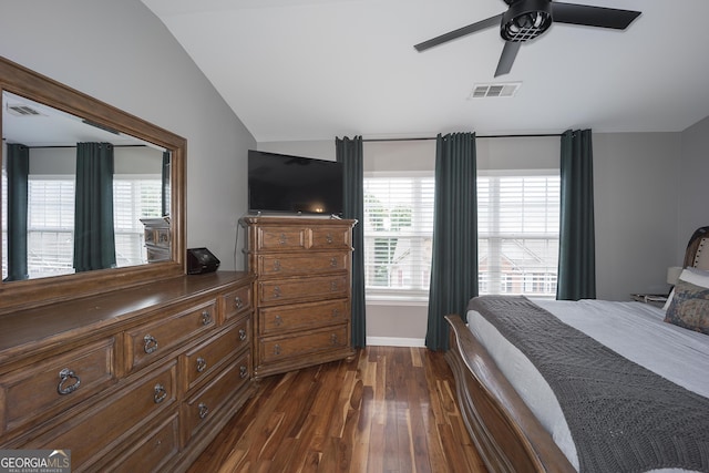 bedroom with dark wood finished floors, lofted ceiling, a ceiling fan, and visible vents