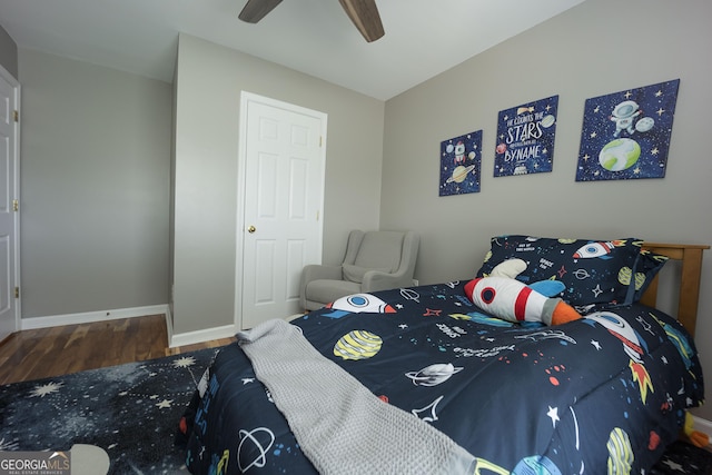 bedroom featuring a ceiling fan, wood finished floors, and baseboards