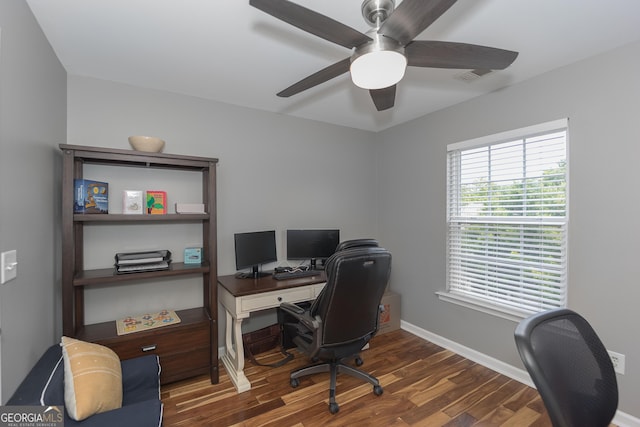 home office featuring baseboards, wood finished floors, visible vents, and ceiling fan