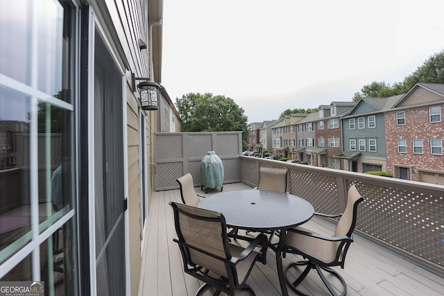 balcony with outdoor dining area and a residential view