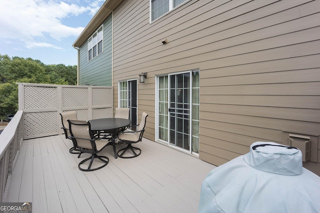 wooden terrace with outdoor dining area