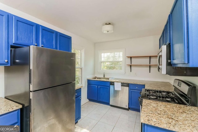 kitchen featuring blue cabinets, open shelves, a sink, stainless steel appliances, and light tile patterned floors