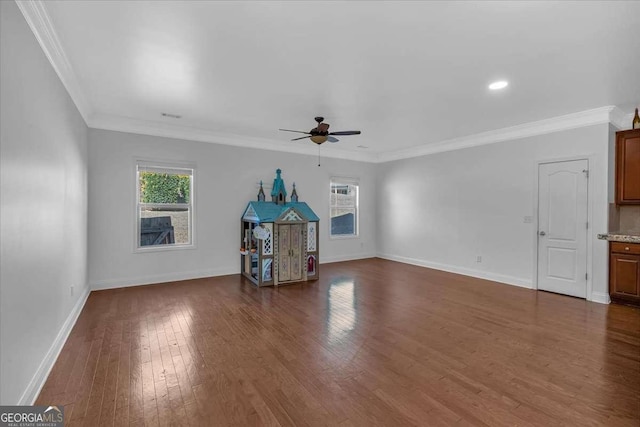 unfurnished living room featuring dark wood-style floors, baseboards, ceiling fan, and ornamental molding