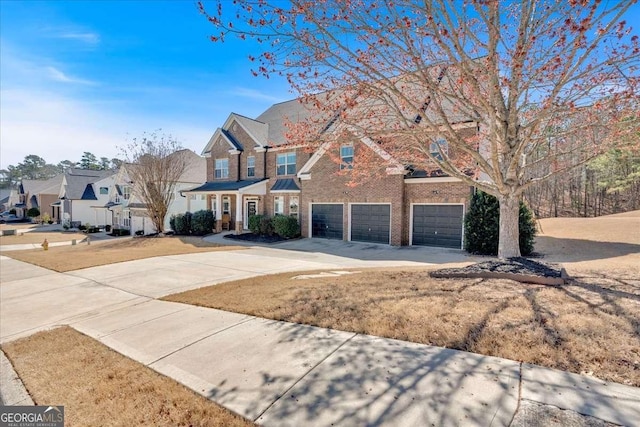 traditional-style home featuring brick siding, a residential view, concrete driveway, and a garage