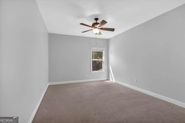 spare room featuring baseboards, a ceiling fan, and carpet floors