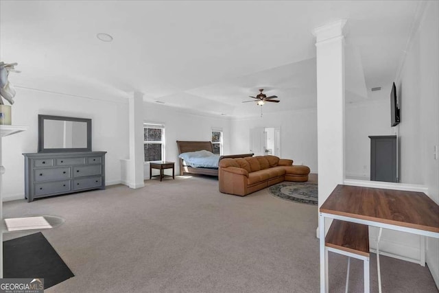 bedroom featuring carpet, ornate columns, and ceiling fan