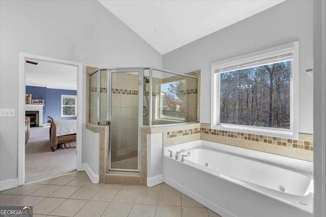 ensuite bathroom with ensuite bath, a stall shower, a whirlpool tub, vaulted ceiling, and tile patterned floors