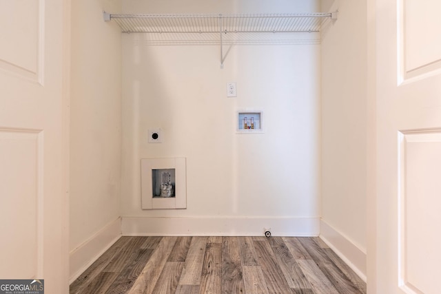 laundry room with hookup for a washing machine, hookup for an electric dryer, baseboards, and wood finished floors