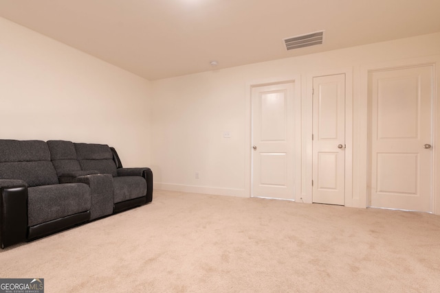 living area featuring visible vents, carpet floors, and baseboards