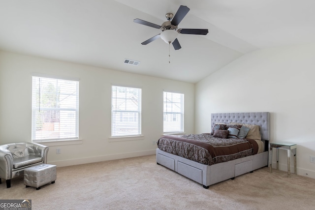 carpeted bedroom featuring visible vents, multiple windows, baseboards, and lofted ceiling