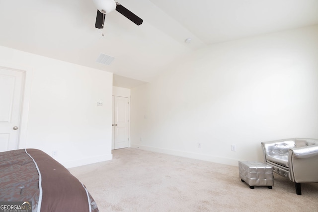 living area featuring a ceiling fan, visible vents, baseboards, lofted ceiling, and carpet flooring