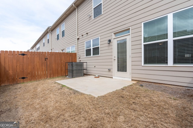 exterior space with a yard, central AC unit, a patio, and fence