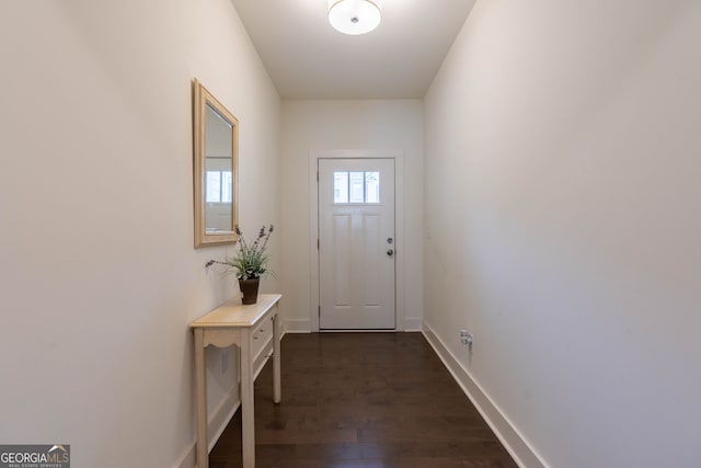 entryway with dark wood-style floors and baseboards