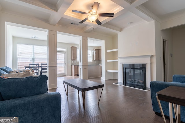 living area featuring a ceiling fan, visible vents, coffered ceiling, decorative columns, and dark wood-type flooring