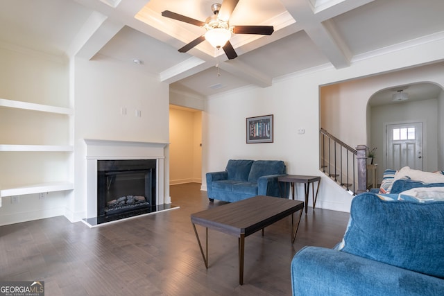 living room featuring stairs, wood finished floors, arched walkways, and ceiling fan