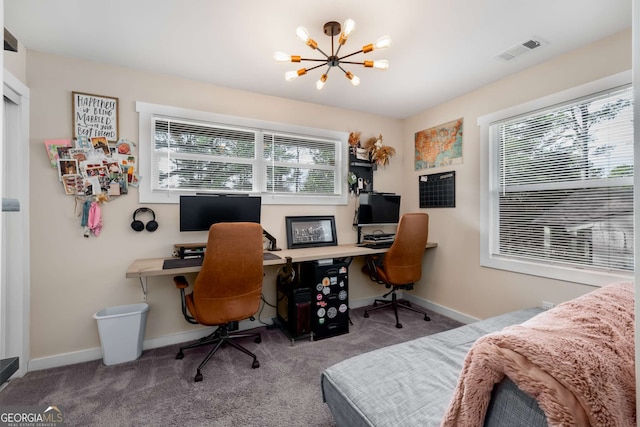 carpeted office space with an inviting chandelier, plenty of natural light, baseboards, and visible vents