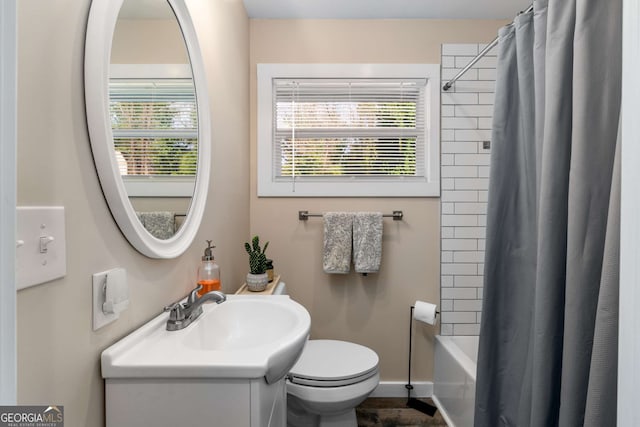 bathroom featuring vanity, toilet, baseboards, and shower / tub combo with curtain