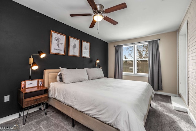 carpeted bedroom with a ceiling fan, an accent wall, and baseboards