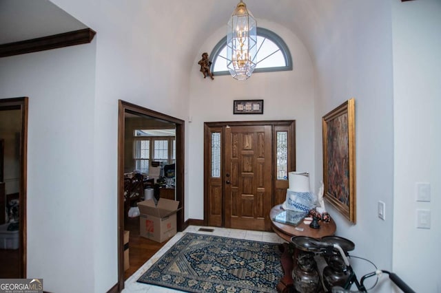 foyer entrance with tile patterned floors, visible vents, plenty of natural light, and a chandelier