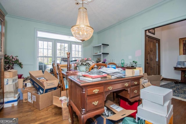 home office featuring a chandelier, wood finished floors, and ornamental molding