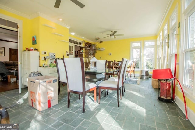 sunroom / solarium featuring ceiling fan