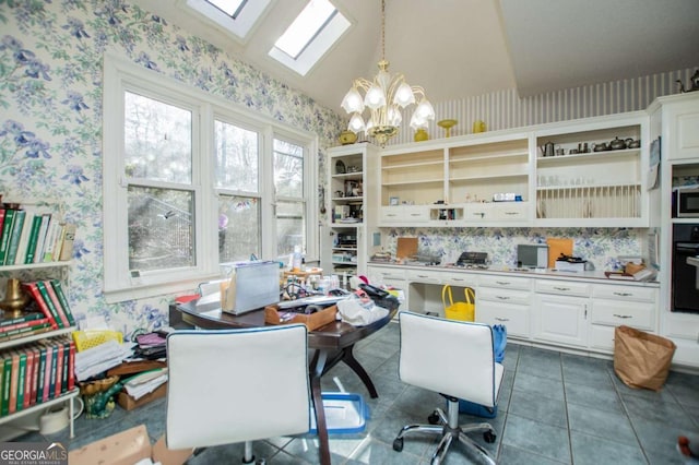 office area featuring tile patterned flooring, a notable chandelier, vaulted ceiling with skylight, and wallpapered walls