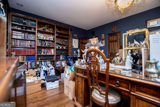 office with a notable chandelier and wood finished floors