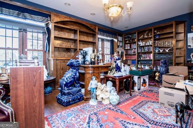 office space featuring a notable chandelier and wood finished floors