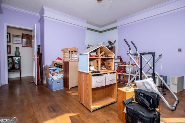 rec room featuring a textured ceiling, wood finished floors, and ornamental molding